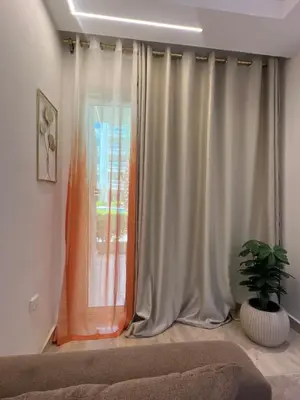a room with a window with curtains and a plant at Avin Resort Hurghada in Hurghada