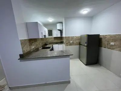 a large kitchen with a sink and a refrigerator at Avin Resort Hurghada in Hurghada