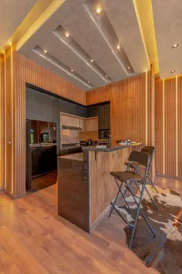 a kitchen with a bar and a chair in a room at Sahlhasheesh villa with heated pool and Jacuzzi in Hurghada