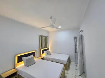 a room with two beds and a ceiling fan at Marina Views Hurghada in Hurghada