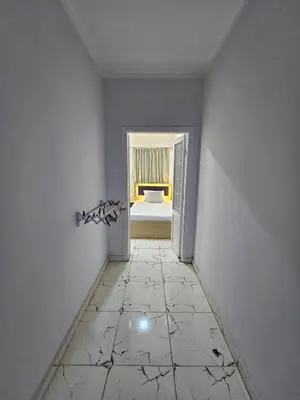 an empty room with a tiled floor and a bedroom at Marina Views Hurghada in Hurghada