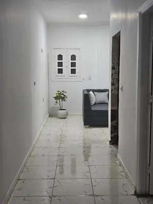 a hallway with a couch and a potted plant at Marina Views Hurghada in Hurghada