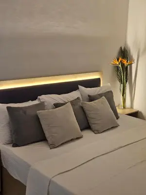 a white bed with a bunch of pillows on it at Marina Views Hurghada in Hurghada