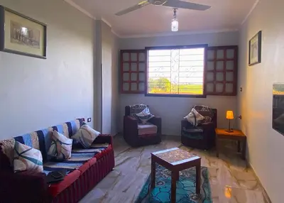 a living room with two couches and a window at Casablanca guest house᭄ꦿ in Luxor