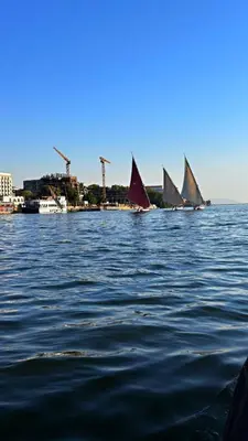 a group of sailboats on the water with a city at Casablanca guest house᭄ꦿ in Luxor