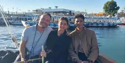 three people sitting on a boat in the water at Casablanca guest house᭄ꦿ in Luxor