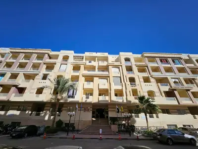a large white building with stairs in front of it at Private Garden Studio Wi-Fi and Beach Access in Hurghada