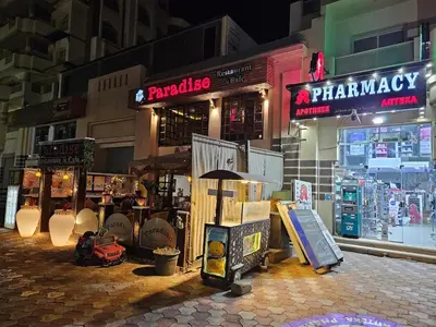 a street at night with a store with signs at Private Garden Studio Wi-Fi and Beach Access in Hurghada
