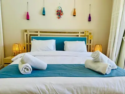 a bedroom with a large bed with towels on it at Cozy apartment in Mangroovy in Hurghada