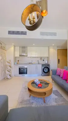 a living room with a couch and a coffee table at Cozy apartment in Mangroovy in Hurghada