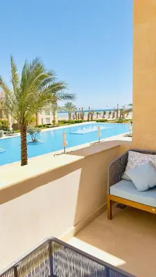 a resort balcony with a view of a swimming pool at Cozy apartment in Mangroovy in Hurghada