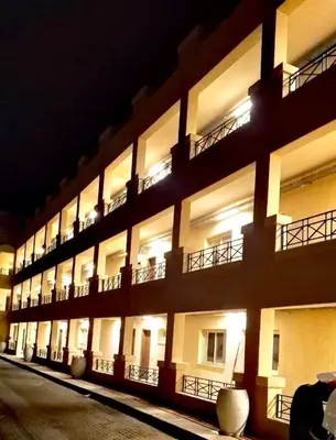 a large building with lit up windows at night at Sahl hashesh Resort in Hurghada