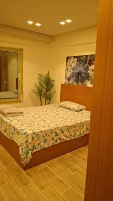 a bedroom with a bed and a mirror at Sahl hashesh Resort in Hurghada