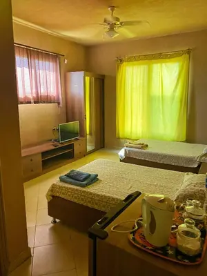 a room with two beds and a table with a tray of food at Luxury Sea-View Villa with Private Pool with Diving center & Beach access in Marsa Alam