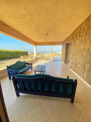 a large living room with a couch and a table at Luxury Sea-View Villa with Private Pool with Diving center & Beach access in Marsa Alam