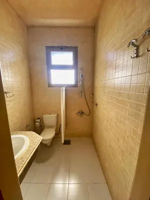 a bathroom with a toilet and a sink and a window at Luxury Sea-View Villa with Private Pool with Diving center & Beach access in Marsa Alam