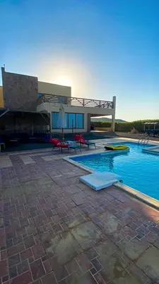 a house with a swimming pool and a building at Luxury Sea-View Villa with Private Pool with Diving center & Beach access in Marsa Alam