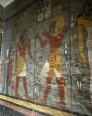 a painting of two men on a wall at Desert Rose in Luxor