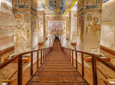 a hallway with paintings on the walls of an ancient building at Desert Rose in Luxor