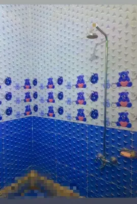 a bathroom with a shower with blue and white tiles at Nubian night in Jazīrat Suhayl