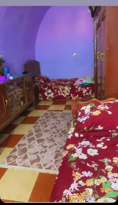 a bedroom with a bed and a purple ceiling at Nubian night in Jazīrat Suhayl