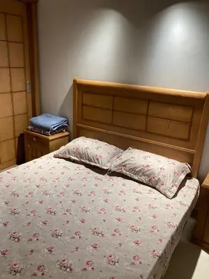 a bedroom with a bed with a wooden headboard at 2 bed rooms apartment in makadi heights in Hurghada