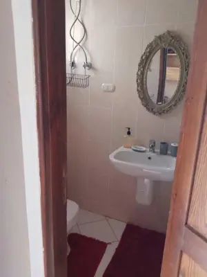 a bathroom with a sink and a mirror at 2 bed rooms apartment in makadi heights in Hurghada