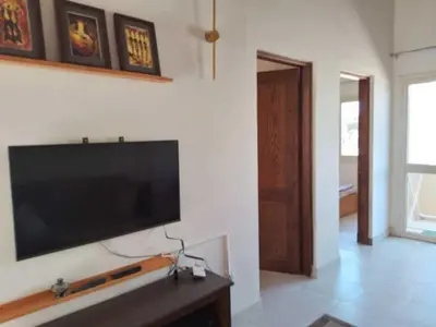 a living room with a flat screen tv on a wall at 2 bed rooms apartment in makadi heights in Hurghada