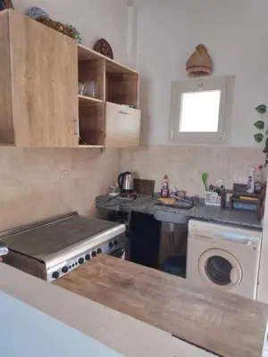 a kitchen with a stove and a washing machine at 2 bed rooms apartment in makadi heights in Hurghada