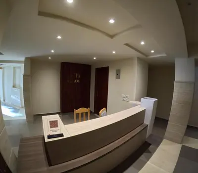a lobby with a bench and a table and chairs at avenue compound in Hurghada