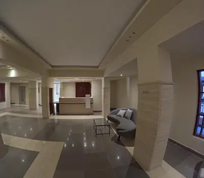 a lobby with a chair and a couch in a building at avenue compound in Hurghada