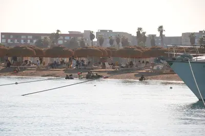 a group of people on the beach near the water at avenue compound in Hurghada