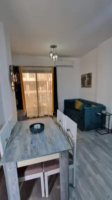 a living room with a table and a couch at Imperial resort Hurghada, 1 bedroom luxury resort in Hurghada
