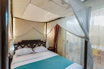 a bedroom with a canopy bed with a window at Al Saraya Sahl Hasheesh by Peaks One Bedroom Apartment With Pool View C101 in Hurghada