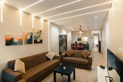a living room with two couches and a tv at Al Saraya Sahl Hasheesh by Peaks One Bedroom Apartment With Pool View C101 in Hurghada