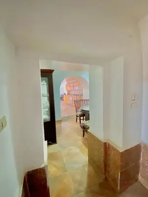 a hallway with a table and a dining room at Yellow House on the Nile in Luxor