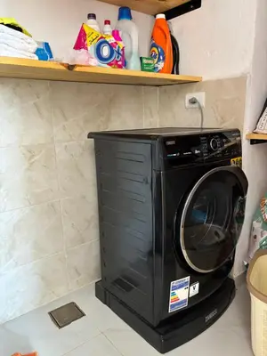 a black washing machine sitting in a kitchen at Villa Golden Mountain in Luxor