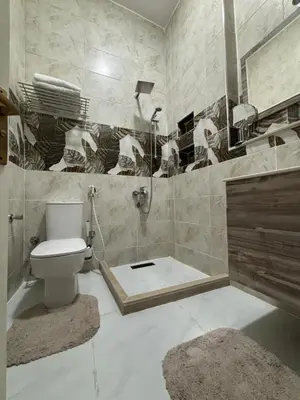 a bathroom with a toilet and a shower and a sink at Villa Golden Mountain in Luxor
