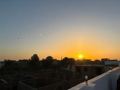 a sunset from the roof of a building at Villa Golden Mountain in Luxor