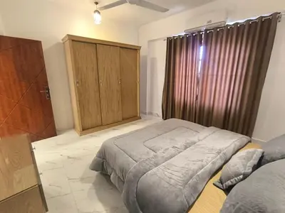 a bedroom with a bed and a wooden cabinet at King House in Luxor