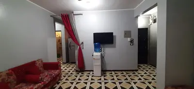 a living room with a couch and a tv at Downtown Apartment in Aswan