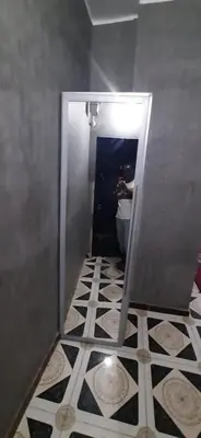 a bathroom with a toilet and a tile floor at Downtown Apartment in Aswan
