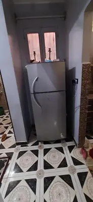 a bathroom with a toilet with two crosses on the wall at Downtown Apartment in Aswan