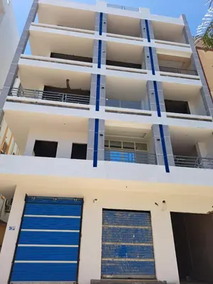 an apartment building with two blue garage doors at Amazing Roof In Marina Hurghada in Hurghada