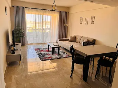 a living room with a couch and a table at Apartment in Port Ghalib Marina City in Port Ghalib