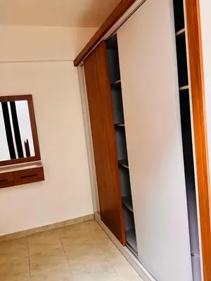 a closet with a wooden door next to a wall at Apartment in Port Ghalib Marina City in Port Ghalib