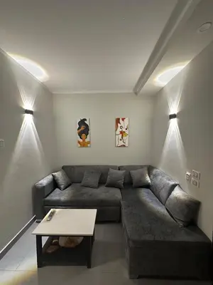 a living room with a couch and a table at Seafront Hotel Apartment with private beach in Hurghada