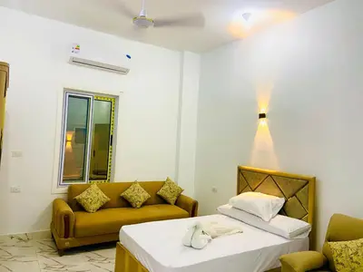 a living room with a bed and a couch at Taha Guest house in Luxor