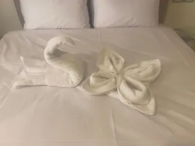 a white bed with a swan made out of towels at Taha Guest house in Luxor