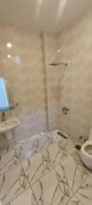 a bathroom with a shower and a toilet and a sink at Taha Guest house in Luxor
